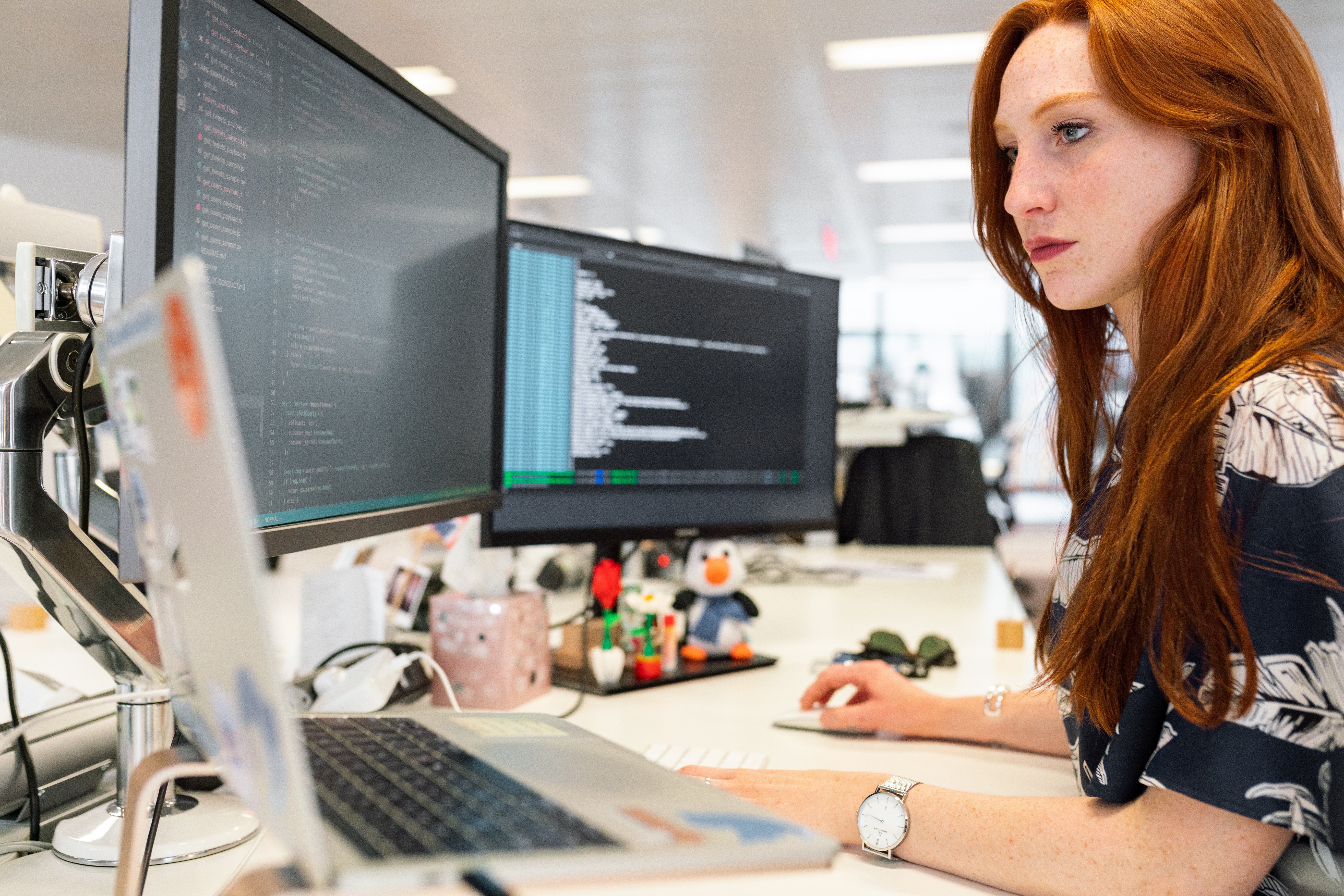 ginger girl reading code on computer